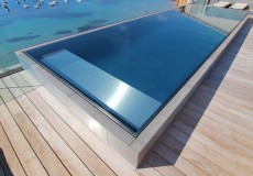Semi-inground swimming pool / stainless steel / self-supporting / overflow